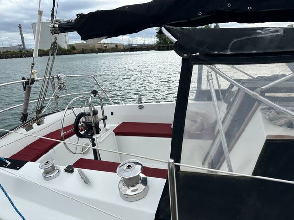 The S2 9.2's aft cockpit offers generous seating with well-cushioned benches and good visibility all around. Note the solid grab rails and properly sized wheel—details that matter when conditions deteriorate. The cockpit's moderate depth strikes a reasonable balance between comfort and safety. Photo courtesy of Boats.com