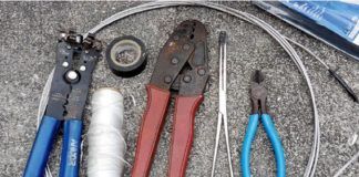 Essential tools for rewriting (left to right): fish tape, RJ45 crimping toolelectrician's tape, 10 pound mason's line (pull string), 1 insulated terminal crimping pliers, long-jawed hemostat, and wire cutters.