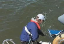 Testers were always tethered to the boat, even in light weather. In heavy weather, two hands are required to manhandle drogues and the deck is moving; the tether saved us from going over many times. A bucket lashed to the stern rain was handy for handling chain rode without scratching gelcoat.