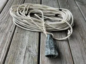 A leadline can be a savior when the depth sounder fails. To be able to read the leadline quickly, even in the dark, a traditional leadline will have leather strips, colored calico, and bunting to mark depth intervals. Webbing, rags, etc. will also work.