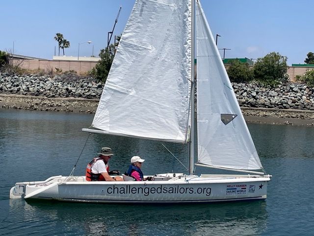 Sailing in light winds with main and jib. Rear tiller control is visible at back of boat, but front sailor is steering. Boom is way above sailors when seated, and there is rarely any reason to leave the seats in the Martin 16. (Photo/ Jane Dunn)