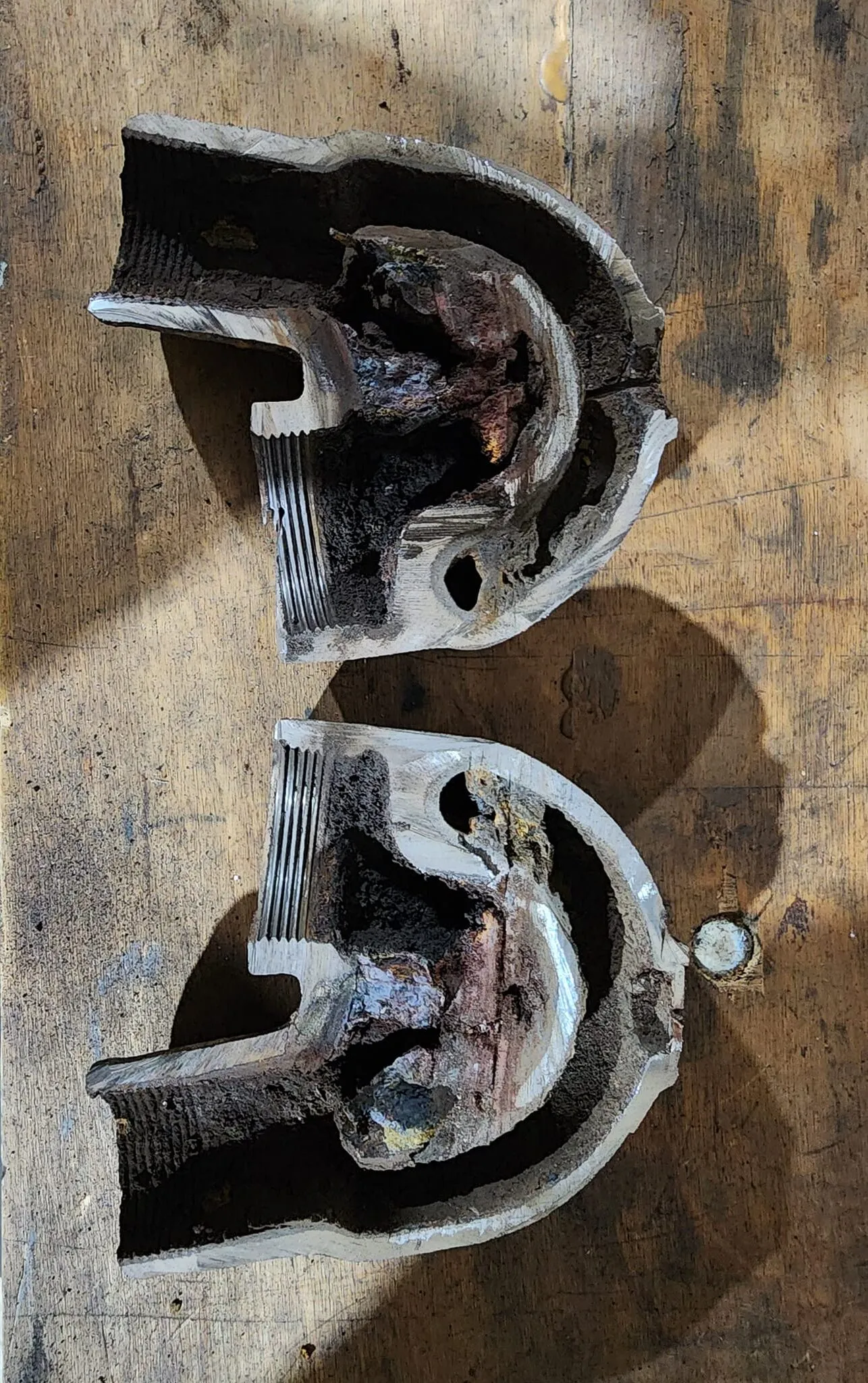 I cut a corroded exhaust elbow in half to show the onset of corrosion. Water intrusion followed and led to problems in the engine block.