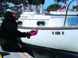 A professional cleaner prepares to dive on one of our former bottom paint test boats, a Cape Dory 28.