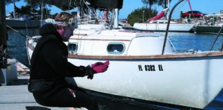 A professional cleaner prepares to dive on one of our former bottom paint test boats, a Cape Dory 28.