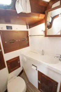 The forward head is easily accessed by both those in the main cabin and the forward cabin. It has all of the cruiser creature-comforts like a freshwater shower, toilet and a sink with pressure hot and cold water. Photo courtesy of Forbes Yachts. 