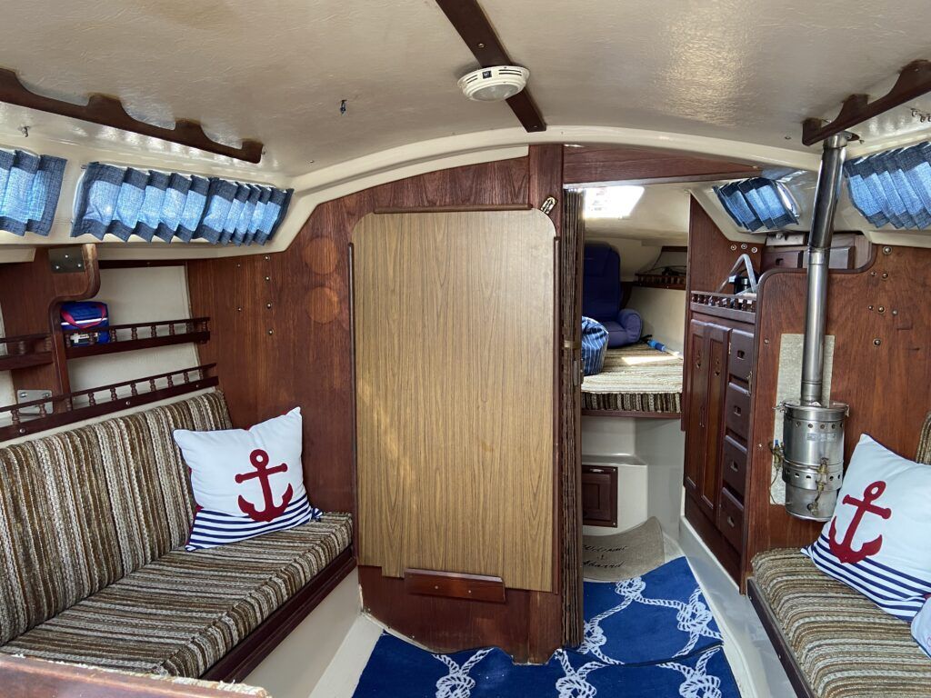 The interior of Rock Steady, a 1978 Catalina 30. The stove heater is unique feature of the boat that we know little about since this was not our install and we don’t use it. From what we know it’s an original feature and was used on the boat's passage from California to the East Coast in the 1980’s, which may have required some heat in the cabin. It’s in beautiful condition and has a vent that goes to the outside on the starboard side. (Photo/ Kim Saylor)