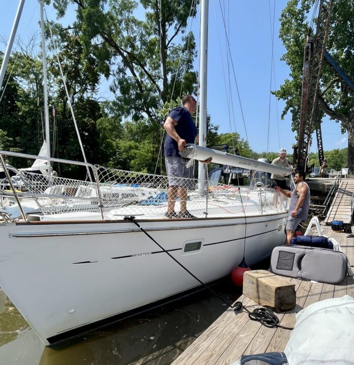 The crew at Hop-O-Nose Marina in Catskill, NY helped us remove our mast. They also helped us build cradles on the deck so that we could carry our mast and rigging on deck as we traveled the Erie Canal. (Photo/ Alison Major)