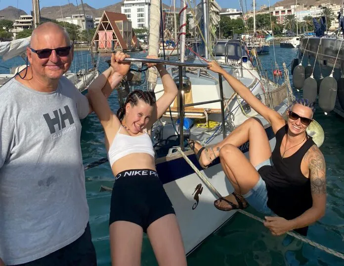 All braided and ready for the Atlantic Leszek Wolnik, left, with granddaughter Reija, center, and crew Marija before their Atlantic crossing on a Vancouver 32. Reija and Marija had their hair braided in preparation for the voyage, while Leszek's hair was naturally voyage-ready. (Photo/ Leszek Wolnik)