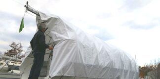 Covering the boat is one of the last steps in the winterizing process which readies all of your boat systems for the coming temperature drop. (Photo/ Marc Robic)