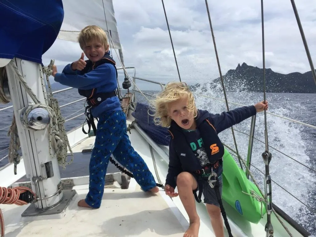 Sailing home after a summer in Northland 2018, harnessed and lifejacketed. Moon River's bow hatch is original and extremely heavy. It was one of the things we replaced. (Photo/ Carolyn Powles)
