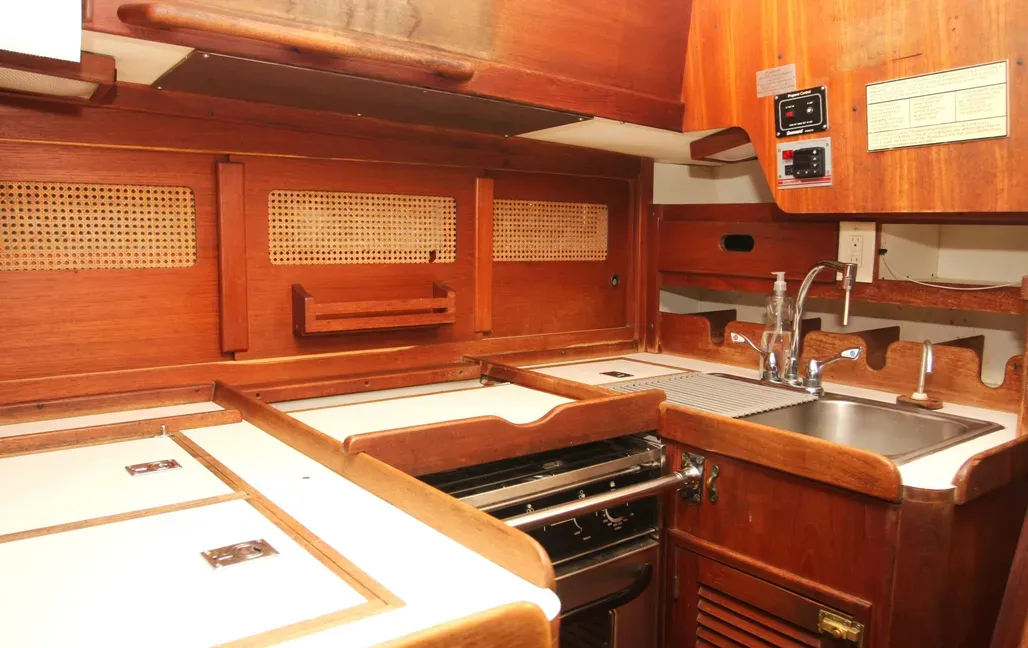 The U-shaped galley is compact but offers all the amenities that a cook could need. Most of the food lockers are outboard, requiring the cook to reach across the stove. This is a 1981 Tartan 37. Photo courtesy of Yacht World.
