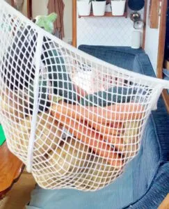Instead of digging into deep storage each time you need a root vegetable or fruit, place the produce you'll be using for a few days in a hanging net. It is easy to access and the ventilation keeps the produce fresh. However, make sure the net is properly tied so that if the boat starts rocking, the net won't swing into anything and create an unwanted fruit salad all over the cabin. (Photo/ Sarah Powell-Fowler)