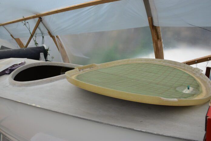 Up-close view of the hatch of an all-GRP boat being made from molds in Bretagne, France. (Photo/ Angie Richard)