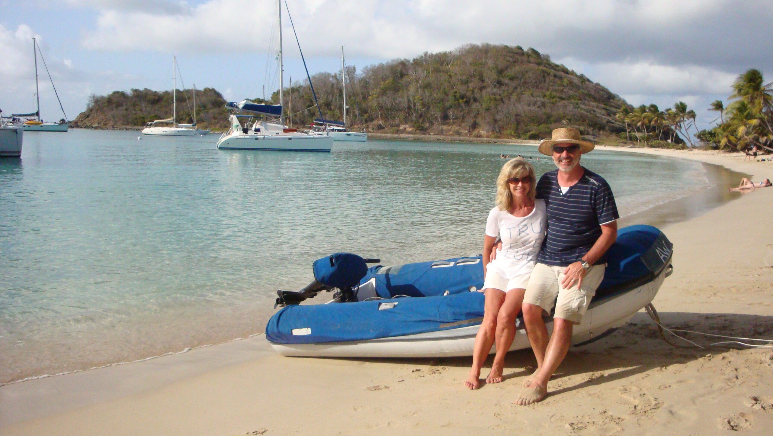 The author and his wife enjoying quiet Salt Whistle Bay, Mayreau in the Grenadines, our chartered Leopard 44 anchored in the background. All charter boats include a tender and outboard. (Photo/ Marc Robic)