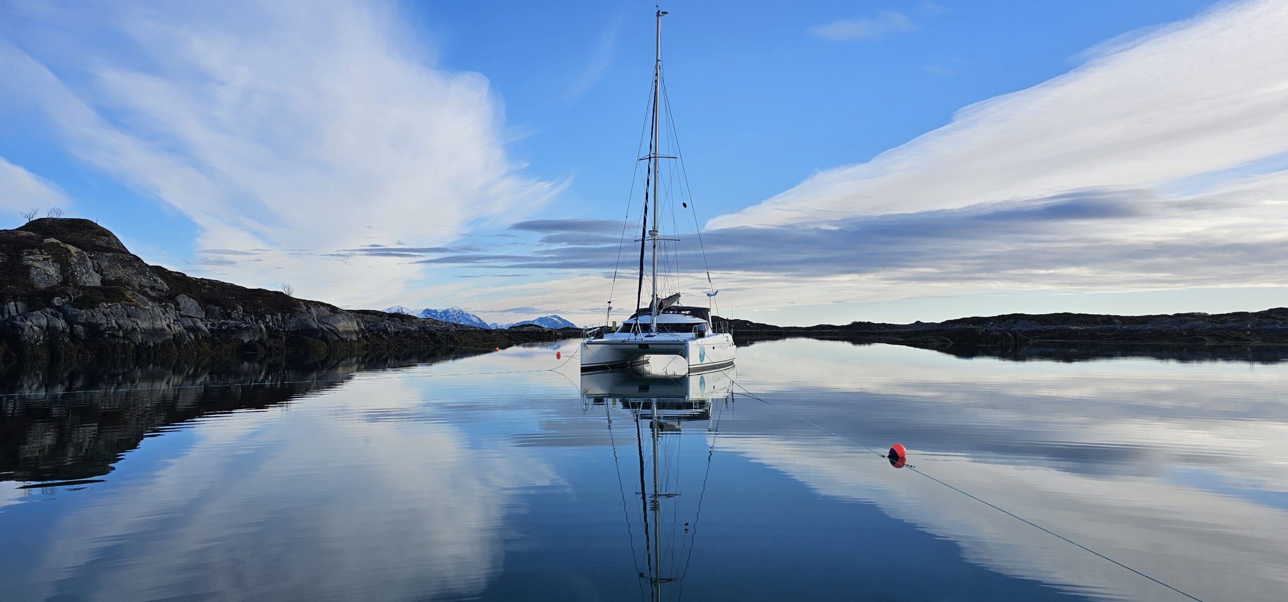 Ellen and Birger choose their anchorages carefully because weather conditions are less predictable in the far north. They anchor Haftor and use float lines secured to rocks to ensure a safe night's rest.