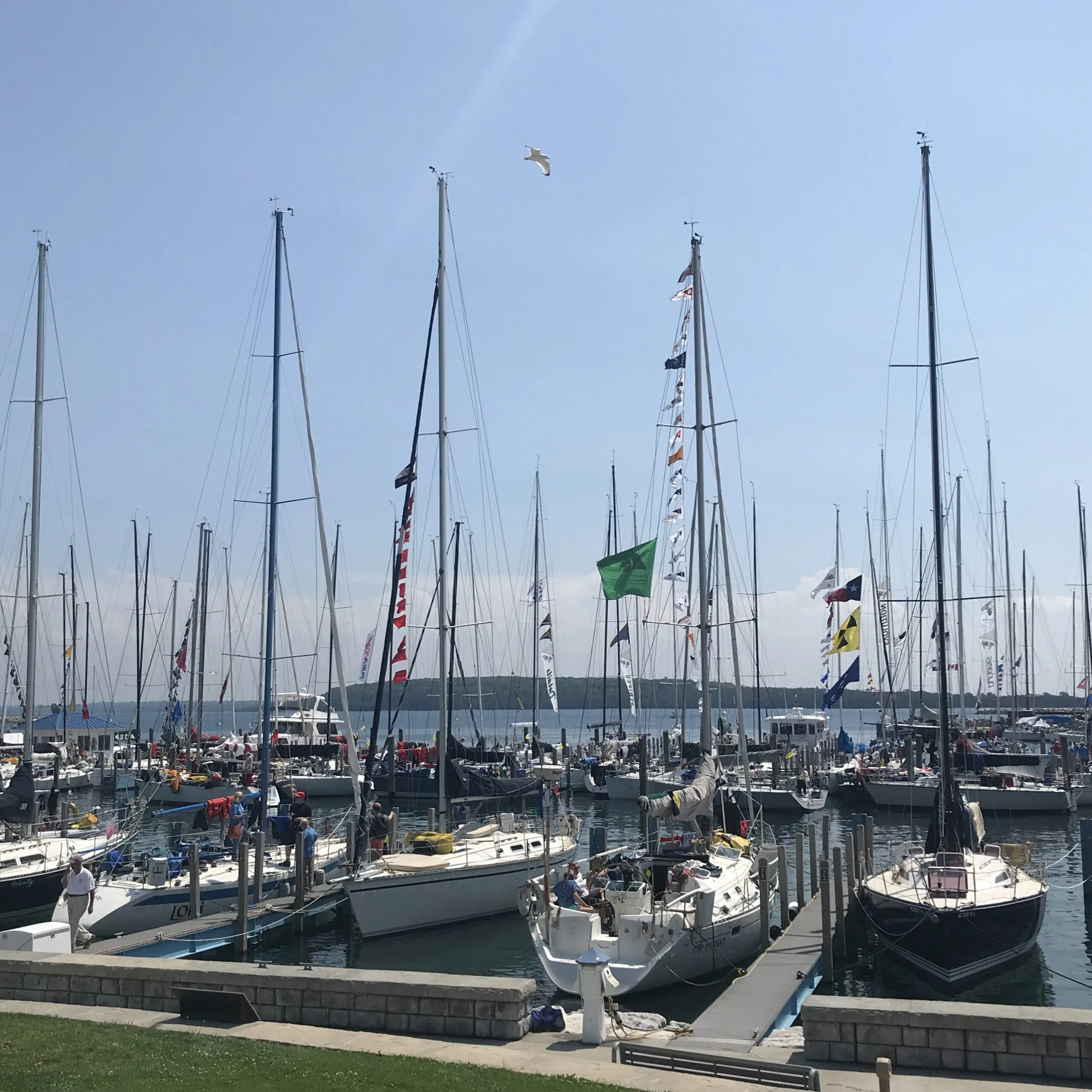 The Great Lakes are a wonderful cruising ground. In your budget, make sure you allocate funds for transit mooring to allow you to explore harbor towns. This is taken on the lawn in front of Mackinac Harbor after the Race to Mackinac. (Photo/ Nick Van Antwerp)