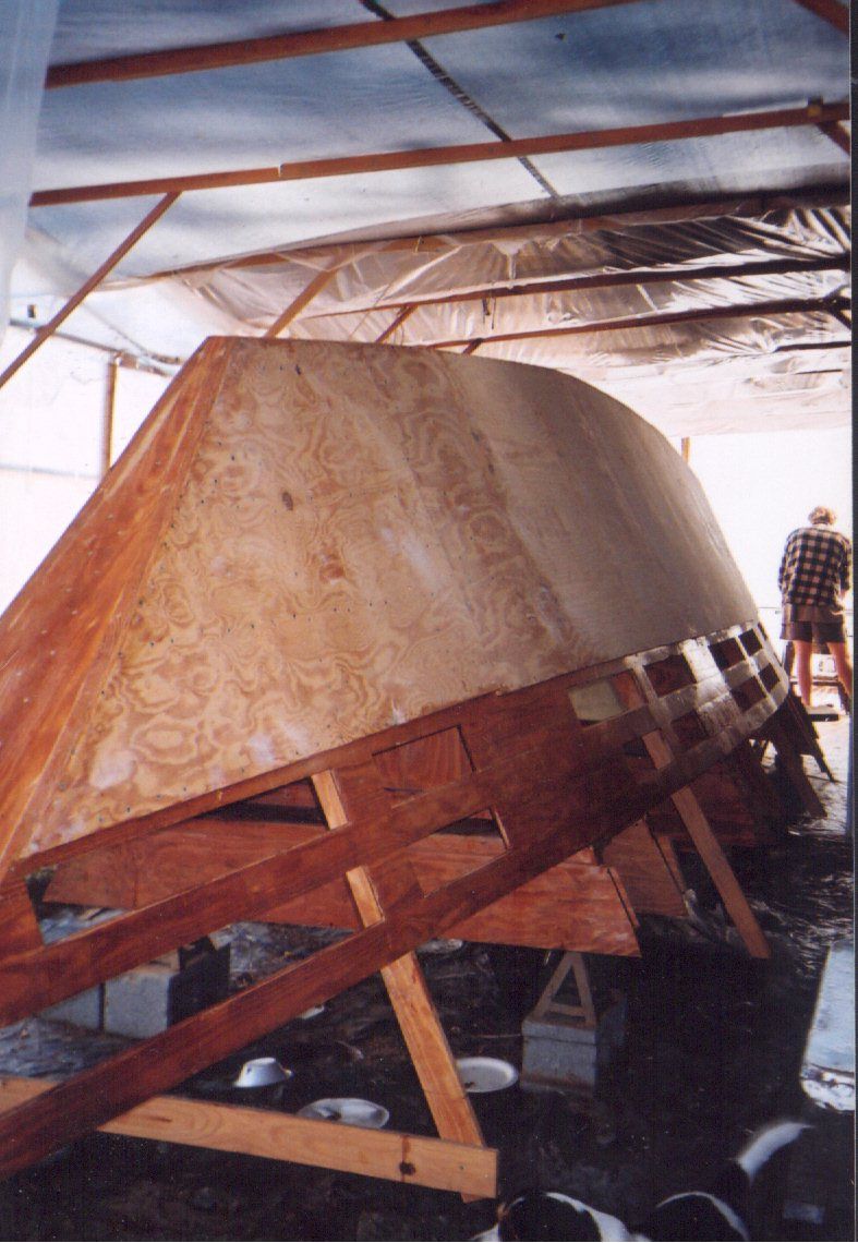 One hull of a Narai Mk IV being built. The ply planks are now going on over the timber "backbone and bulkheads" framing and stringers, which we can see down the bottom. James Wharram's revolutionary “backbone and bulkheads” method uses the boat’s own structure as the guide, for a drastic reduction of pieces of wood, measurement and saw cuts to reach the final ply planking stage. With the classic designs, there were no metal fixings, just glue—urea-formaldehyde at first, then resorcinol, and today, epoxy. (Photo/ Craig Kuhn/ Wharram Designs)