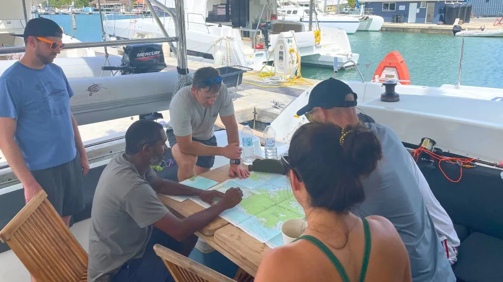 Pre-departure chart and boat briefing on-board. An essential part of a successful trip that all members of your party should attend. (Photo/ Marc Robic)