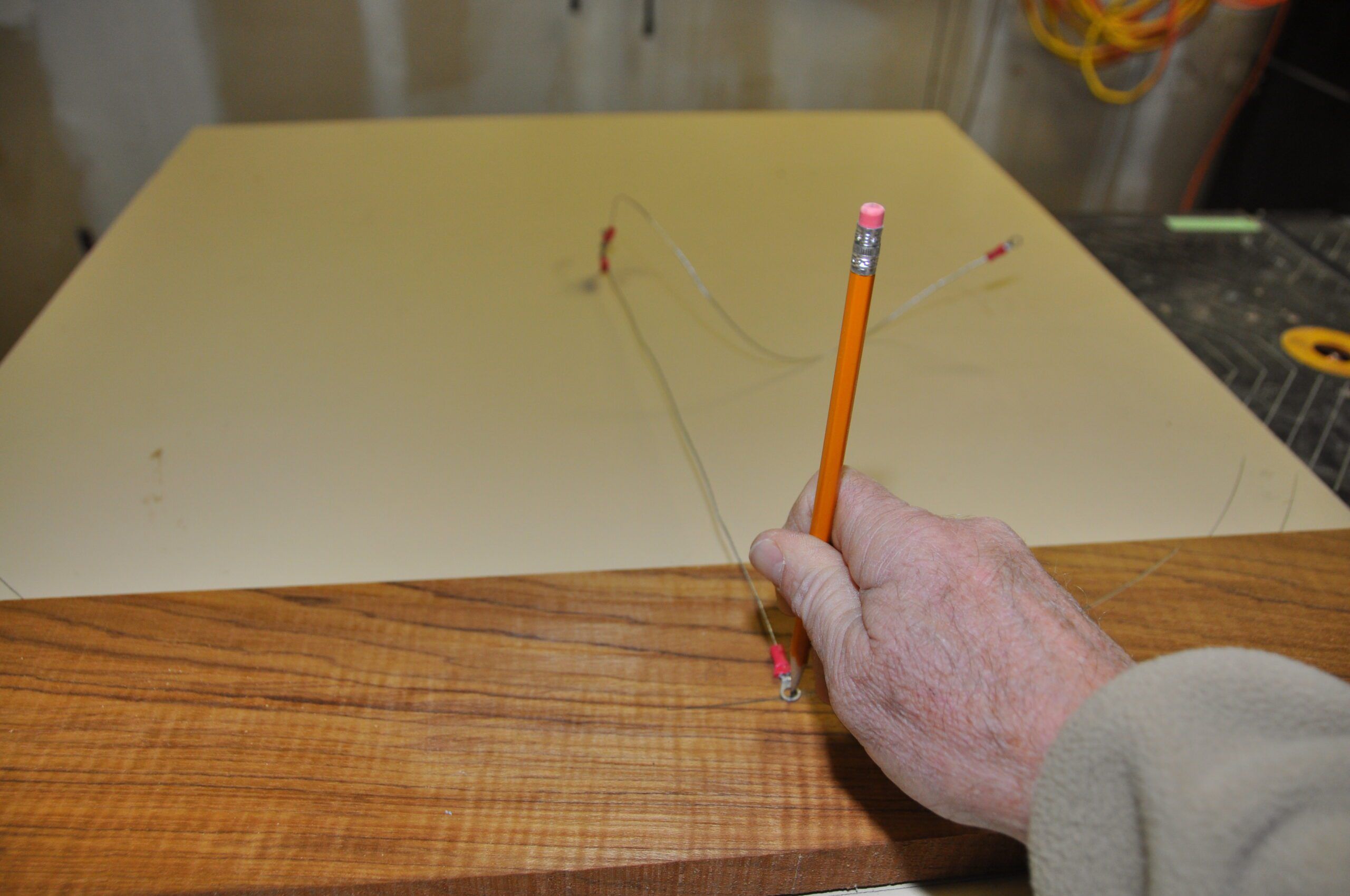 An old countertop and a nail with a wire used to measure the wheel radius and then cutting lines onto the teak plank. (Photo/ Bert Vermeer) 