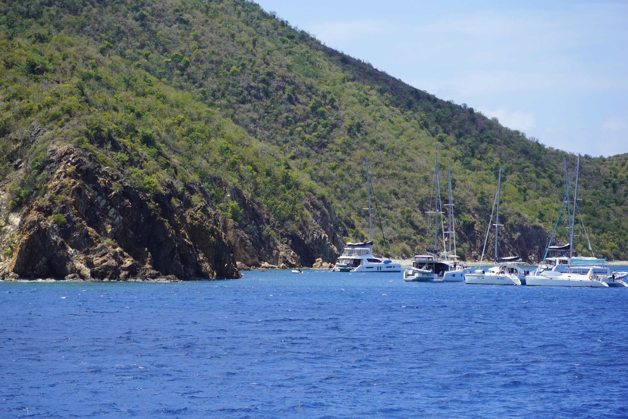 Boats moored at The Caves of Norman Island for snorkelling. (Photo/ Mary Baratto/ Getty)