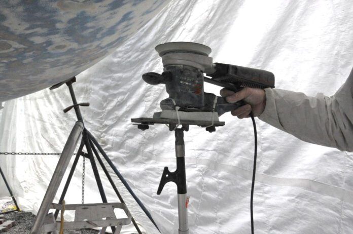 sanding4 (1) Instead of holding a sander above your head for hours, use a foam block, boat hook and zip ties to create a support. (Photo/ Bert Vermeer)