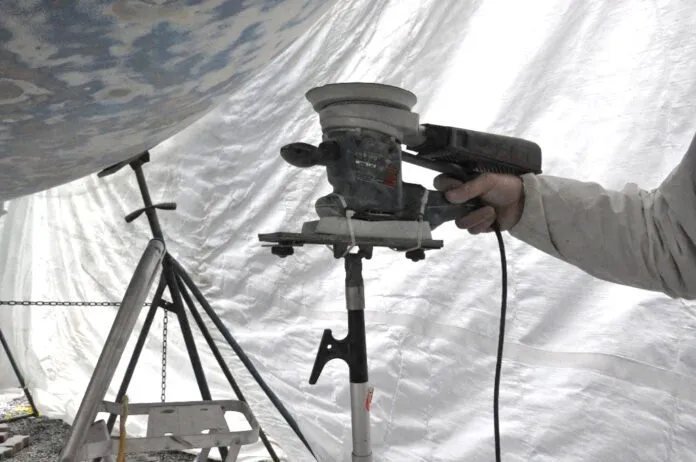 Instead of holding a sander above your head for hours, use a foam block, boat hook and zip ties to create a support. (Photo/ Bert Vermeer)