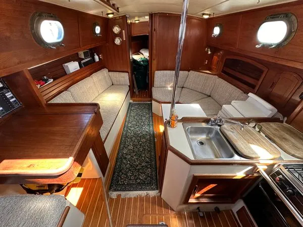 Attractive and commodious, the 37's saloon boasts practical touches like grab rails, hand holds, and upright bottle stowage in the folding table. Photo courtesy of Boats.com.