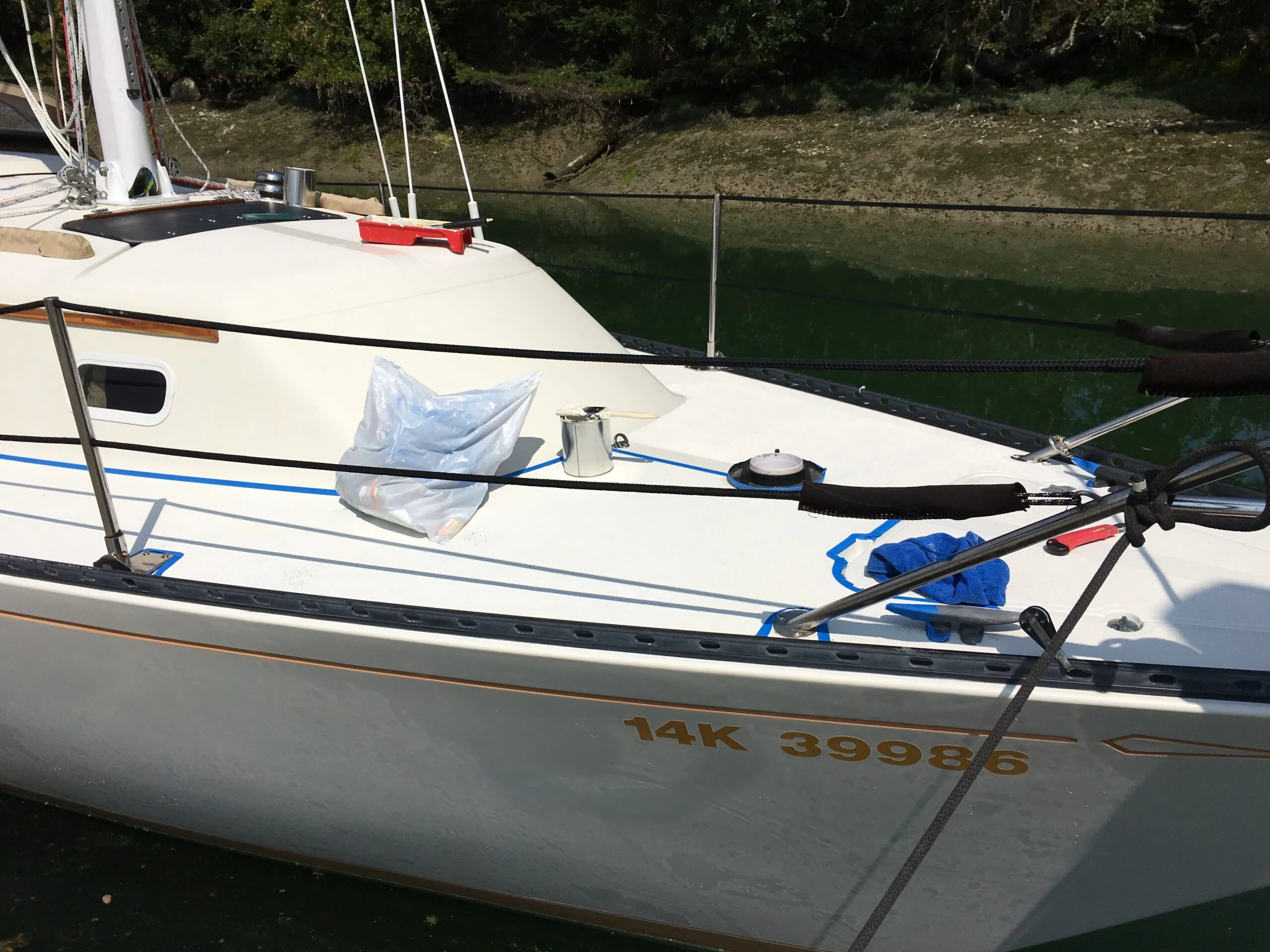The port deck with its new KiwiGrip surface and masking tape removed. The starboard side is masked and ready for KiwiGrip application once the port side dries. (Photo/ Bert Vermeer)