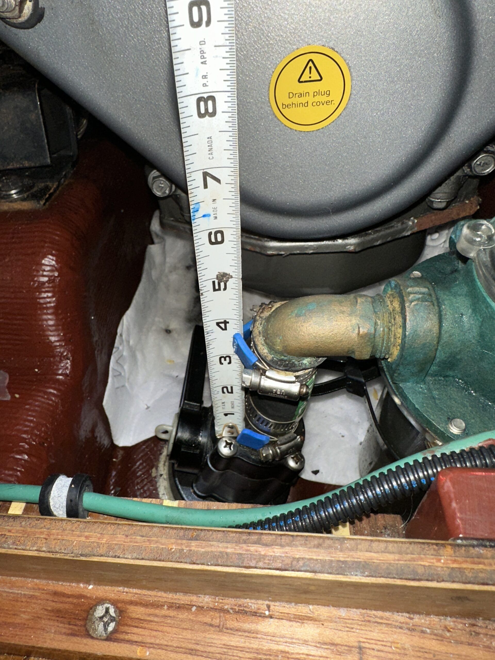 The length of the hose from the seacock barb to the elbow barb. At this time I was still thinking of the "T" solution. The sea strainer is to the right. (Photo/ Bert Vermeer)