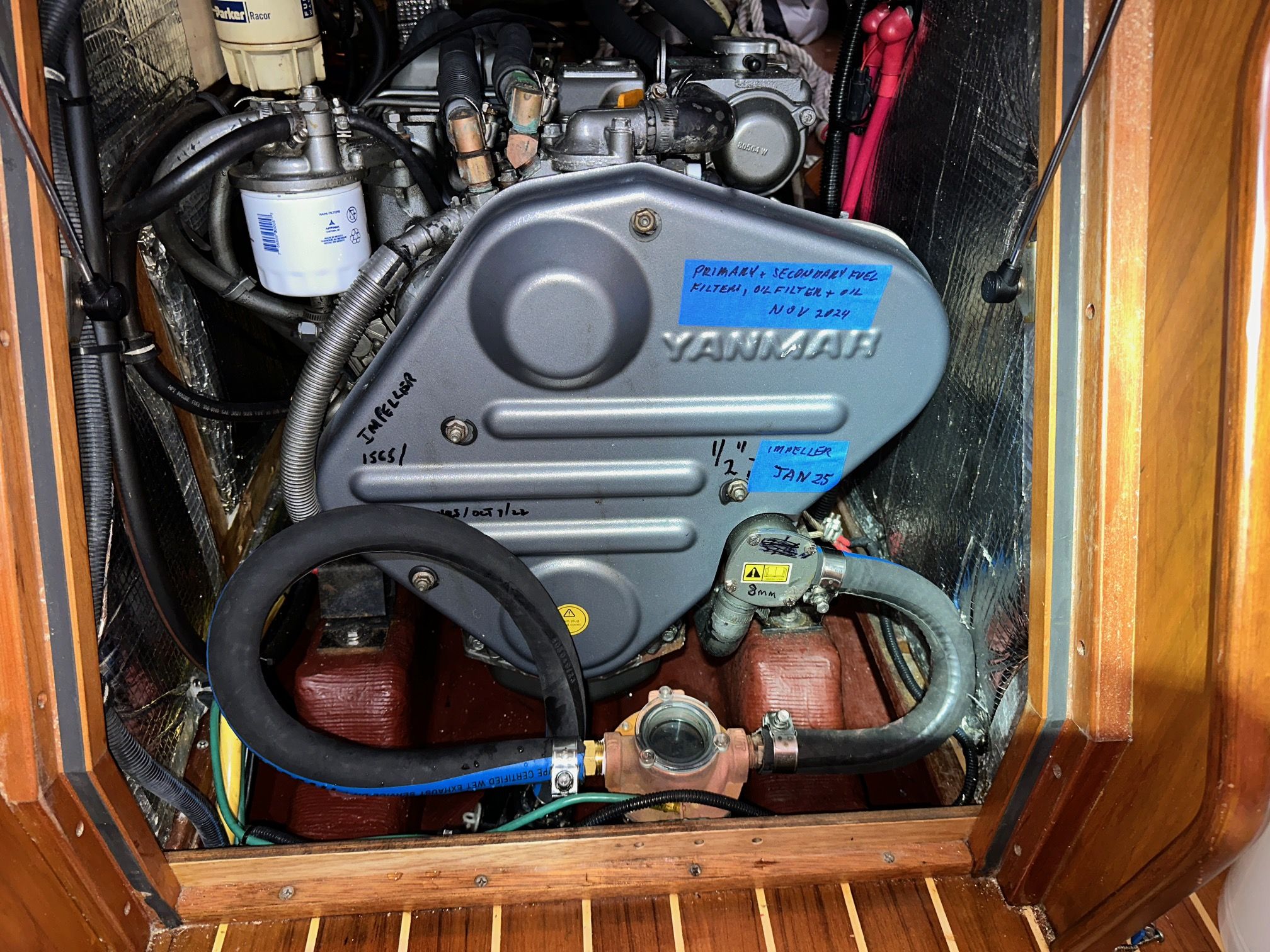 This is the completed set-up. The hardwall hose is curled around and attached to the sea strainer. The belt cover on the Yanmar 3JH4E diesel has masking tape labels indicating oil and fuel filter changes along with raw water impeller replacement dates, just as a reminder when opening up the compartment to open the engine raw water intake. (Photo/ Bert Vermeer)