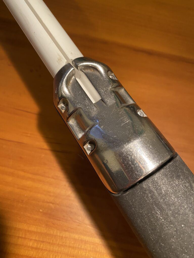 The stainless plate designed to feed the sail’s luff tape also clamps down on the foil with four Allen-head bolts. (Photo/ Doug Henschen)