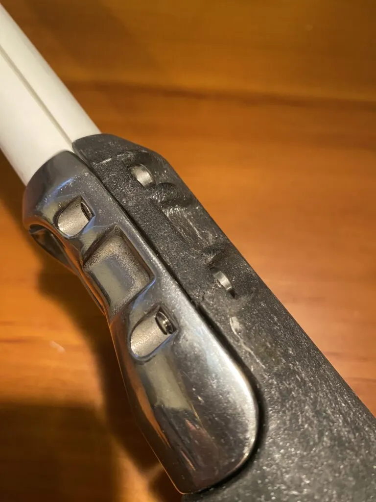Wear or overtightening led to a hairline crack in the fibrous plastic torsion tube, visible in line with the lower bolt. (Photo/ Doug Henschen)