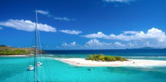 If you frequently charter, then a "charter to ownership" model may appeal to you. A catamaran at Sandy Spit, British Virgin Islands, Caribbean. (Photo/ cdwheatley/ Getty)