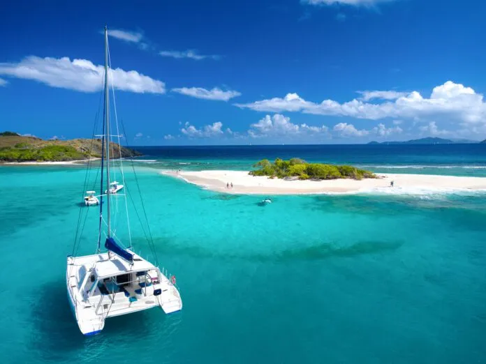 Aerial view of Catamaran at Sandy Spit, British Virgin Islands If you frequently charter, then a "charter to ownership" model may appeal to you. A catamaran at Sandy Spit, British Virgin Islands, Caribbean. (Photo/ cdwheatley/ Getty)