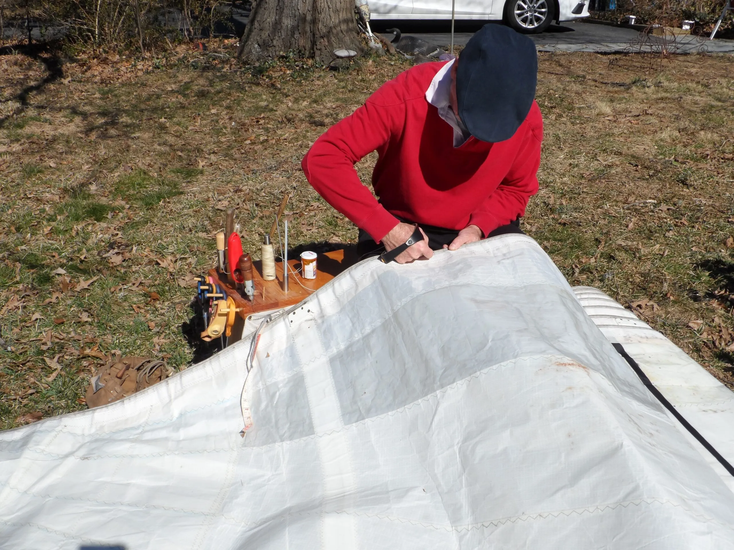 On good weather days, you can take the finishing bench into the yard for sail repairs. (Photo/ Drew Frye)
