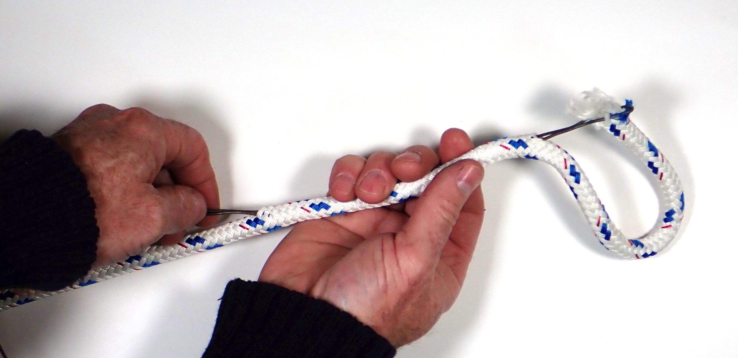 Insert fid at the start of the core taper and exit a little less than half way to the end. Pinch the tapered and frayed end into the wire. (Photo/ Drew Frye)