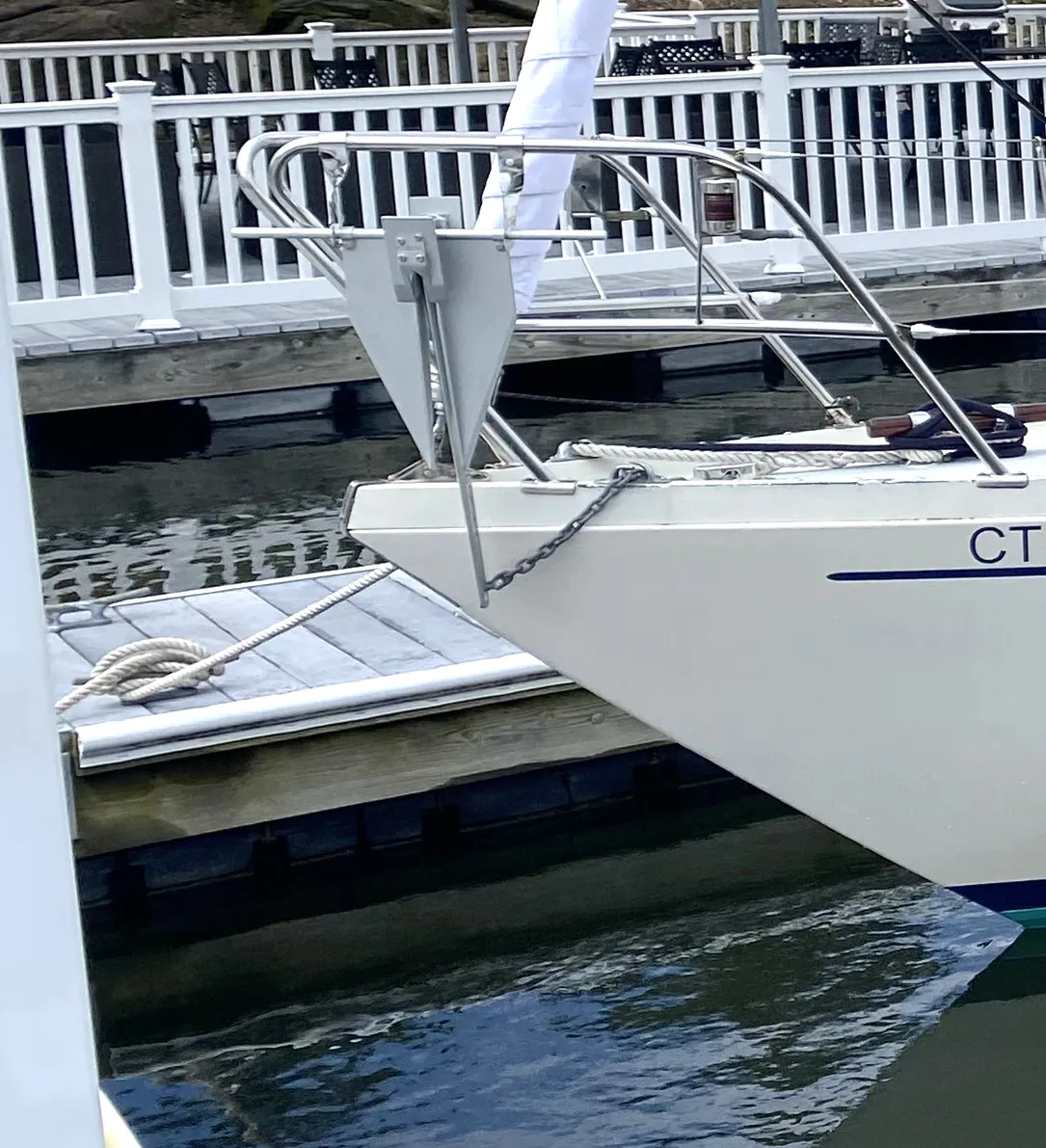 The bow of the author’s boat with the top of the hawse pipe in view along with a Fortress anchor hanging from a Scheafer Marine anchor hanger. A chafe guard has since been added to the chain to protect the toe rail and bow from abrasion. (Photo/ Doug Henschen)