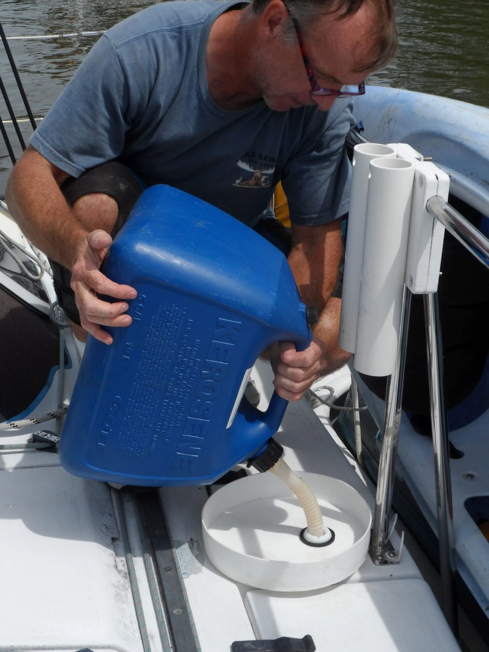 DIY spill catcher. This was our favorite before switching to the shaker siphon. Not for gasoline, because it blocks the ground between the nozzle and the filler fitting. (Photo/ Drew Frye)