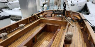 Tally Hos' spacious cockpit, winches close at hand. Alaskan yellow cedar decking with teak trim. The original main sheet gibe buffer is visible over the bronze tiller. Note the high bulwarks without lifelines. (Photo/ Bert Vermeer)