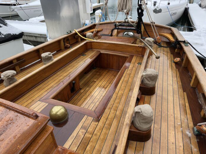Tally Hos' spacious cockpit, winches close at hand. Alaskan yellow cedar decking with teak trim. The original main sheet gibe buffer is visible over the bronze tiller. Note the high bulwarks without lifelines. (Photo/ Bert Vermeer)