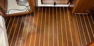 The cabin sole with water damage, looking aft towards the companionway from the salon. The new damage is on the left, while the old damage is near the doorway at the top of the photo. (Photo/ Bert Vermeer)