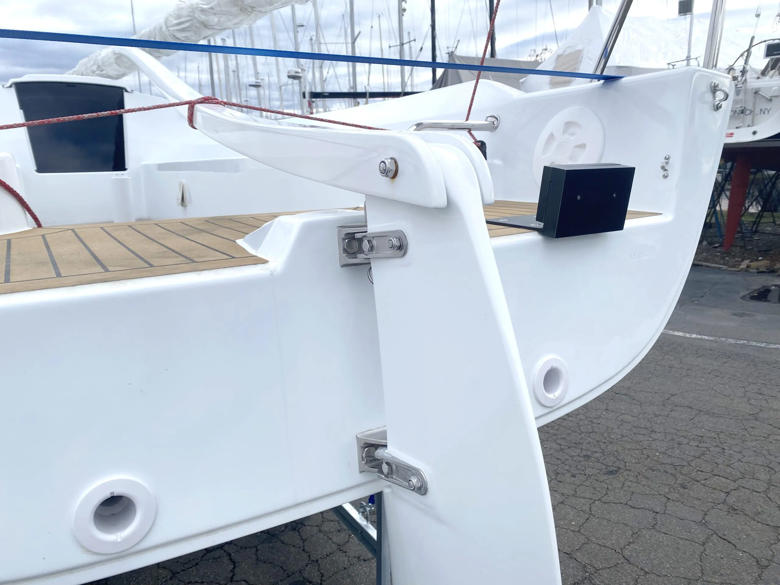 Racers who just need to get out to the buoys might be fine with a 3-hp equivalent electric outboard. The transom of this spanking new (23-ft. 11-in., 2,300 lb.) J/7 has a small (black) motor mount that looks purpose-built for an electric model (or small gas model with an integral tank), as there is no built-in fuel locker. (Photo/ Doug Henschen)