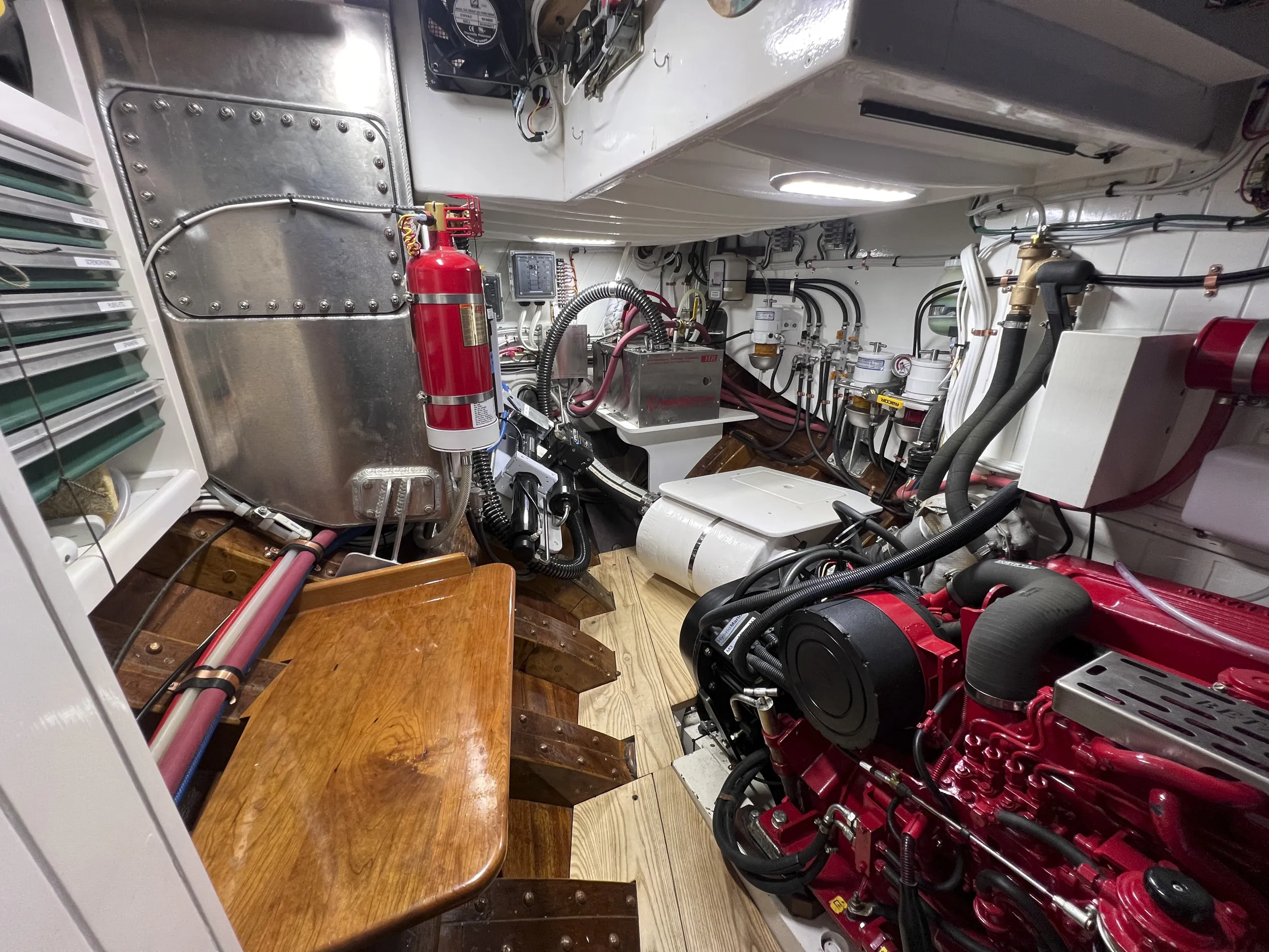 The mechanical palace looking aft. The Beta diesel has excellent access for maintenance with plenty of room to move about. The tool chest is locked in position on the left, hydronic heater aft. Note the ribs under foot and cockpit sole overhead. (Photo/ Bert Vermeer)
