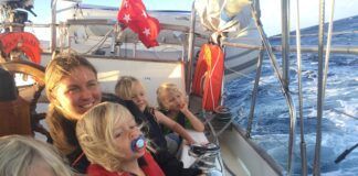 Carolyn Powles with her brood aboard a 1978 Herreshof Mobjack ketch, at sunrise on passage to Fiji. (Photo/ Carolyn Powles)