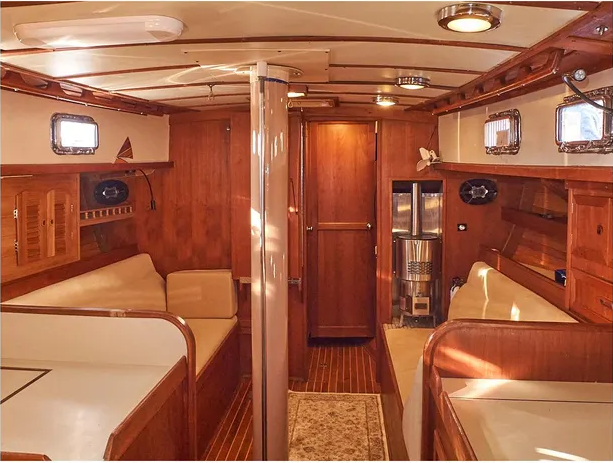 The ample main saloon features a fold-down table and two full-length settees for sea berths during long passages. Offset slightly to port, the companionway’s position allows for a bigger galley and a wider aft cabin. 