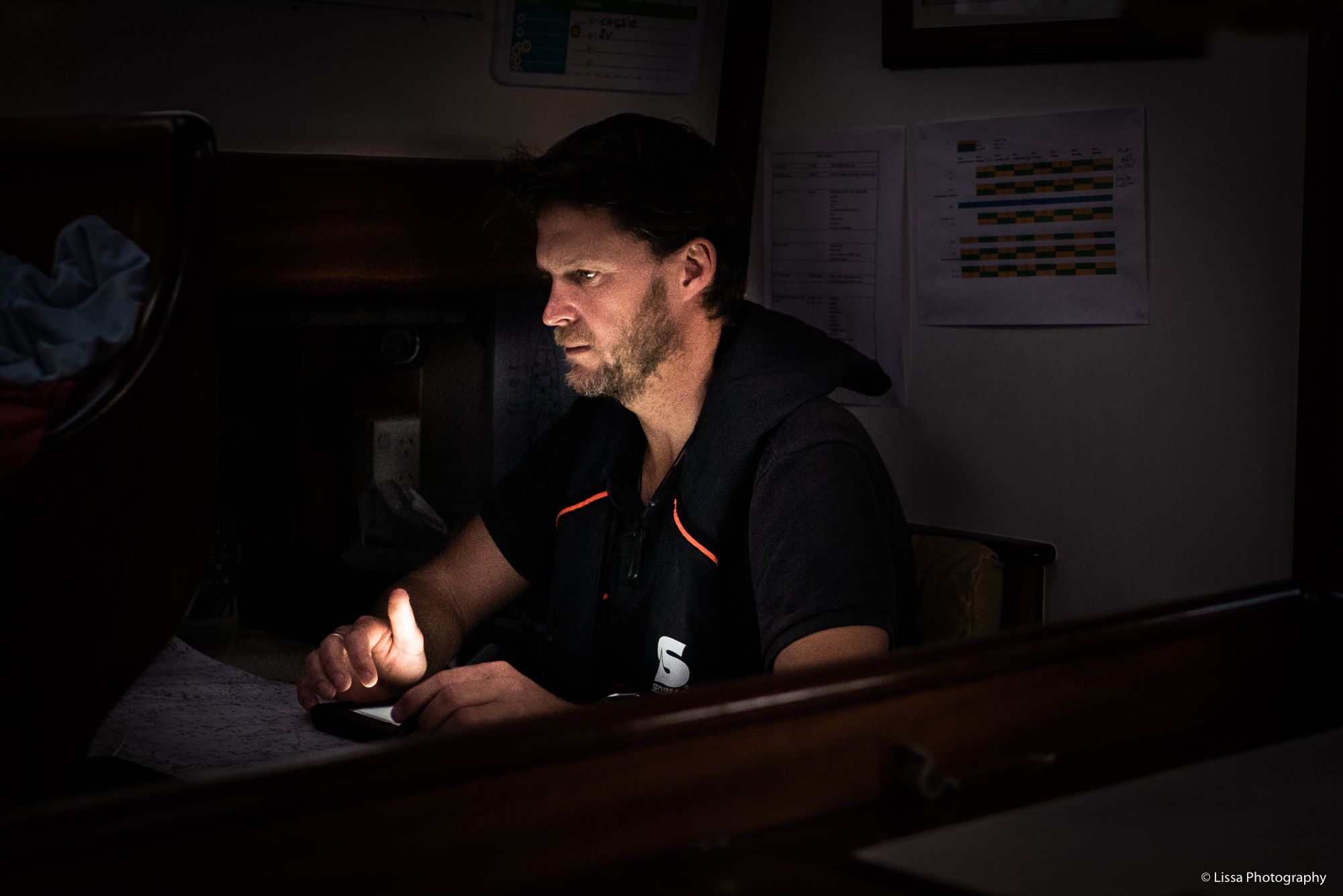 Richie at the nav station during a night watch from New Zealand to Tonga. (Photo/ Lissa Photography)