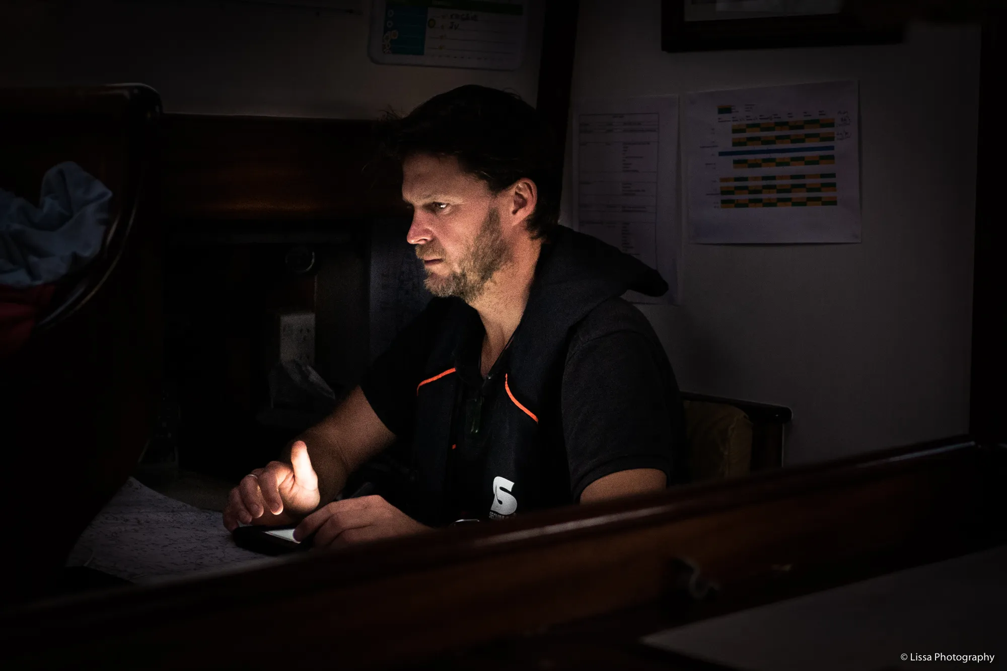 Richie at the nav station during a night watch from New Zealand to Tonga. (Photo/ Lissa Photography)