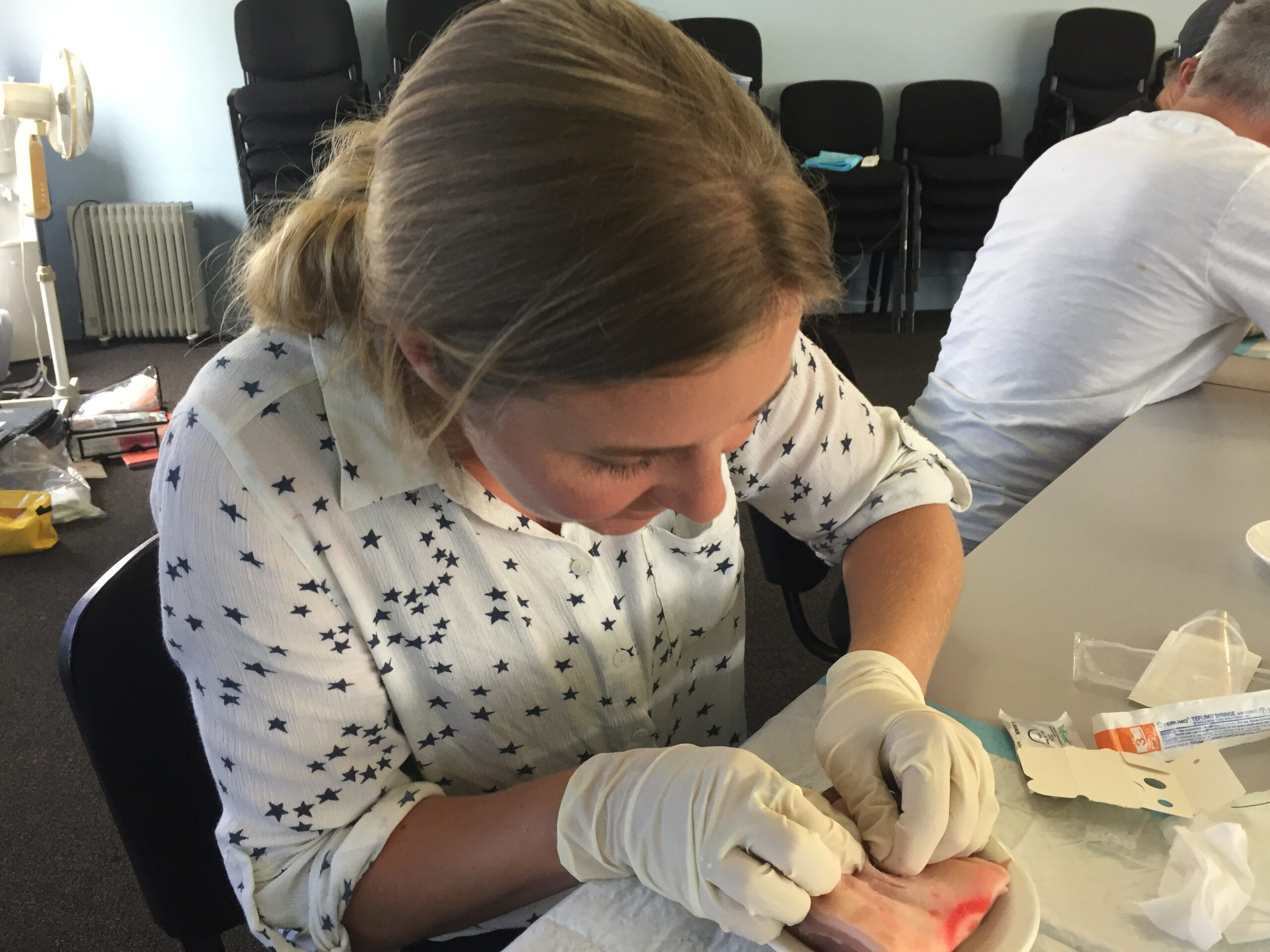 Learning the proper technique for suturing. (Photo/ Carolyn Powles)