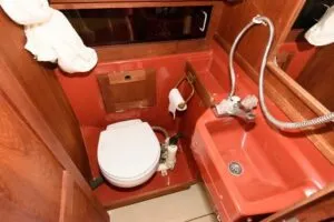 The head includes a built-in vanity and the basics for comfortable cruising. But the space is compact, and the shower drains directly to the bilge, which is less desirable for cleanliness and maintenance. Photo courtesy of SailboatListings.com