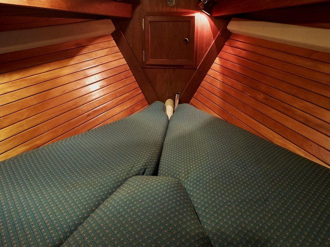 The forepeak could be arranged like a traditional V-berth, but some owners opted for a pullman berth—or storage shelf and additional lockers.